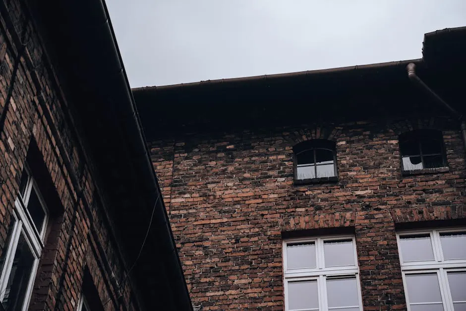 Architectural detail of a brick tenement with vintage windows, showcasing urban living style.